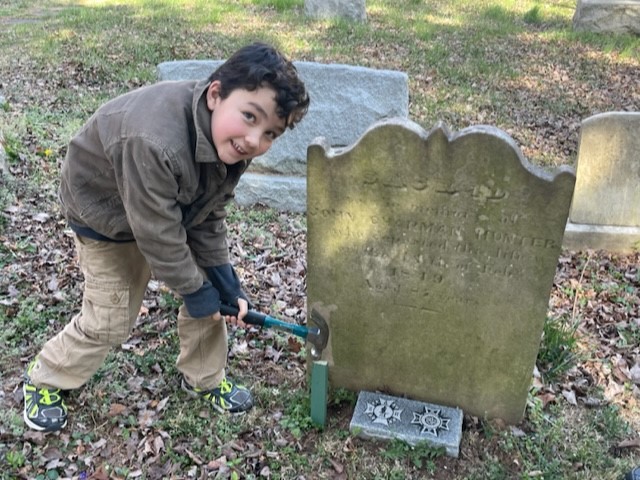 GWSAR Compatriot Luc Chevalier hammers in a marking stake next to patriot gravestone. 